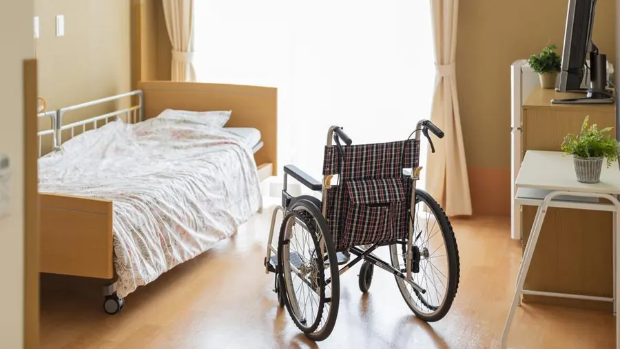 A wheelchair in a hospital room.