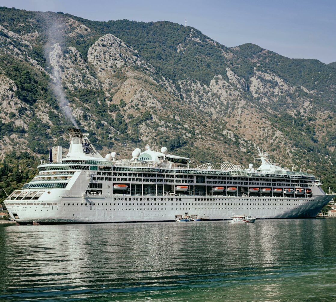 A large cruise ship docked in a body of water.