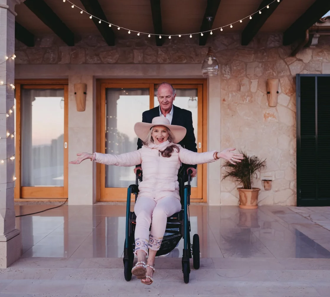 A man in a wheelchair and a woman in a tuxedo.